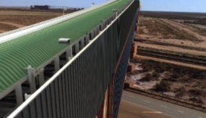 Conveyor span crossing site roadway with skewed supports beyond standard module length.